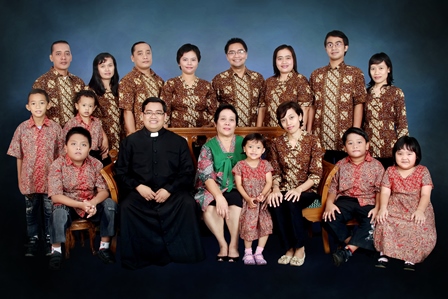 An Indonesia Family in Traditional Clothing A Missionary of the Holy Family priest meets with his family in Indonesia with all wearing traditional outfits.